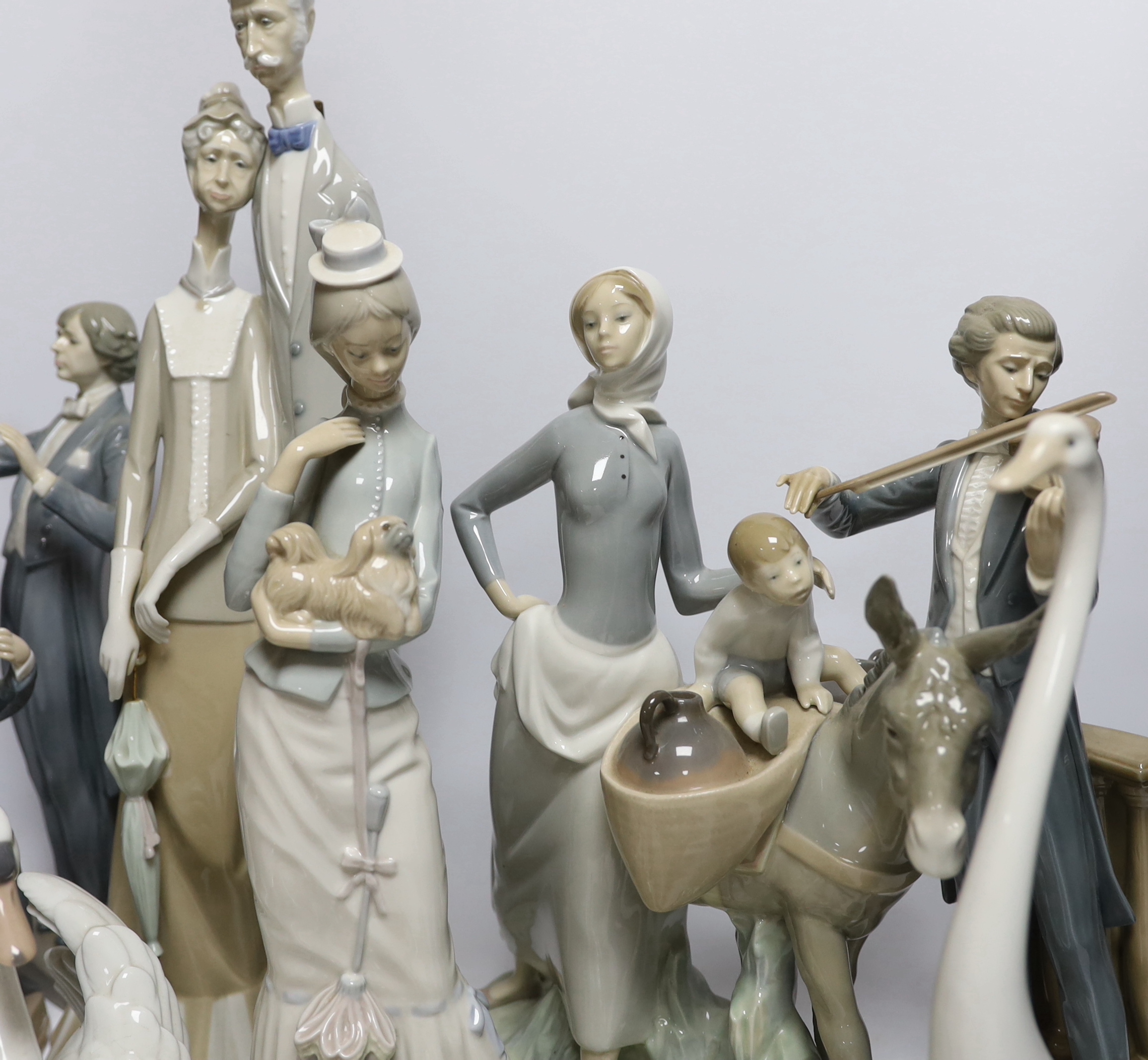 A collection of various Lladro figures including composers, swans, etc. tallest 50cm